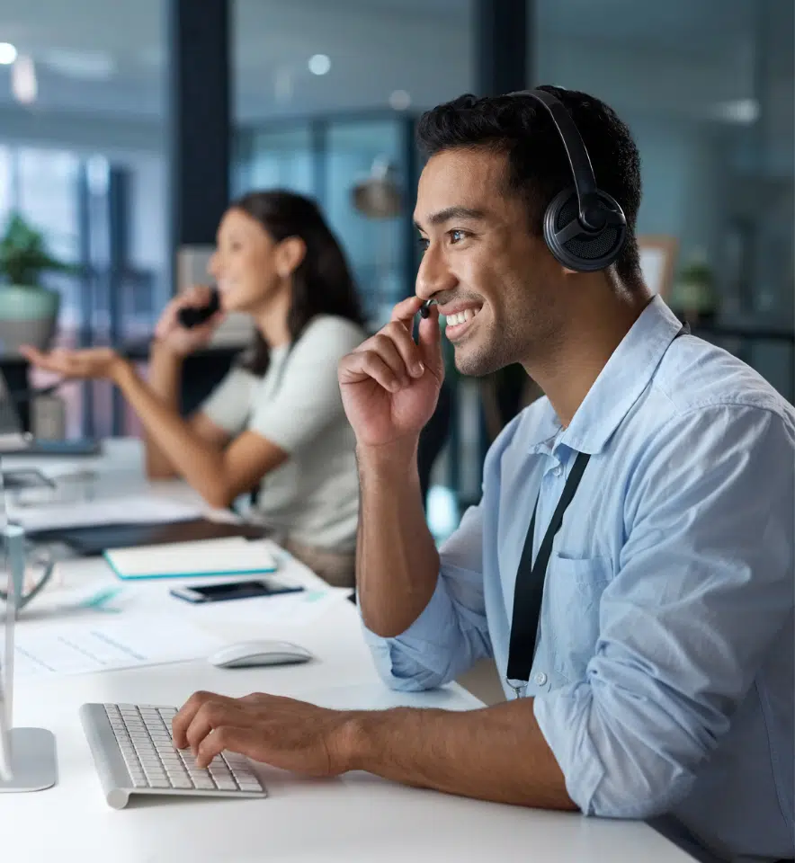 Happy male customer service agent in a call center