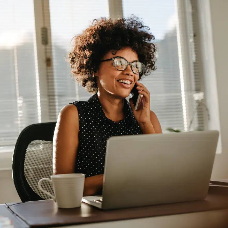 Happy woman talking to a customer on the phone