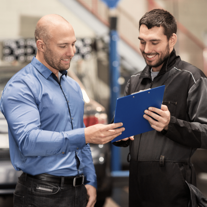 Mechanic speaking confidently with a male customer service training